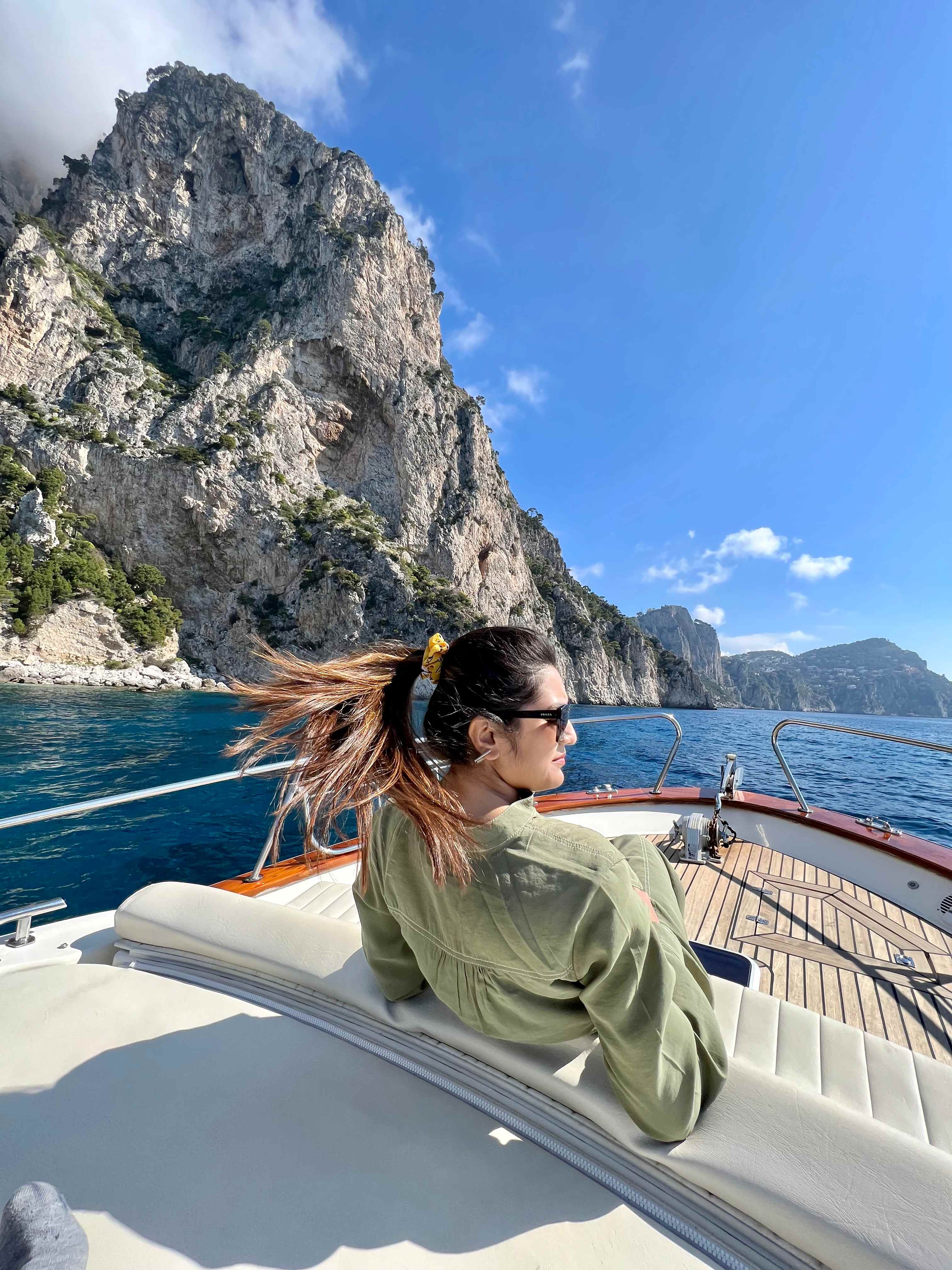 Travel adventure on boat with scenic coastal cliffs, showing curiosity and exploration